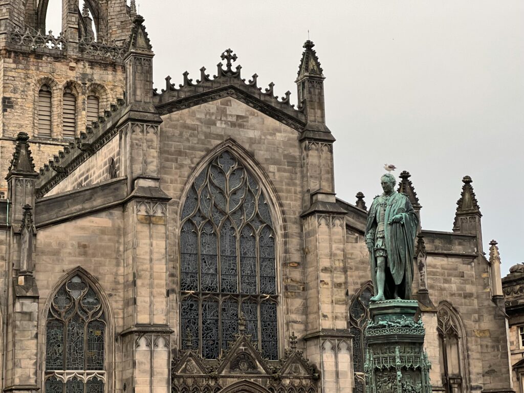 pexels-photo-13629145-13629145 Statue near St Giles' Cathedral showcasing Gothic architecture in Edinburgh, Scotland.