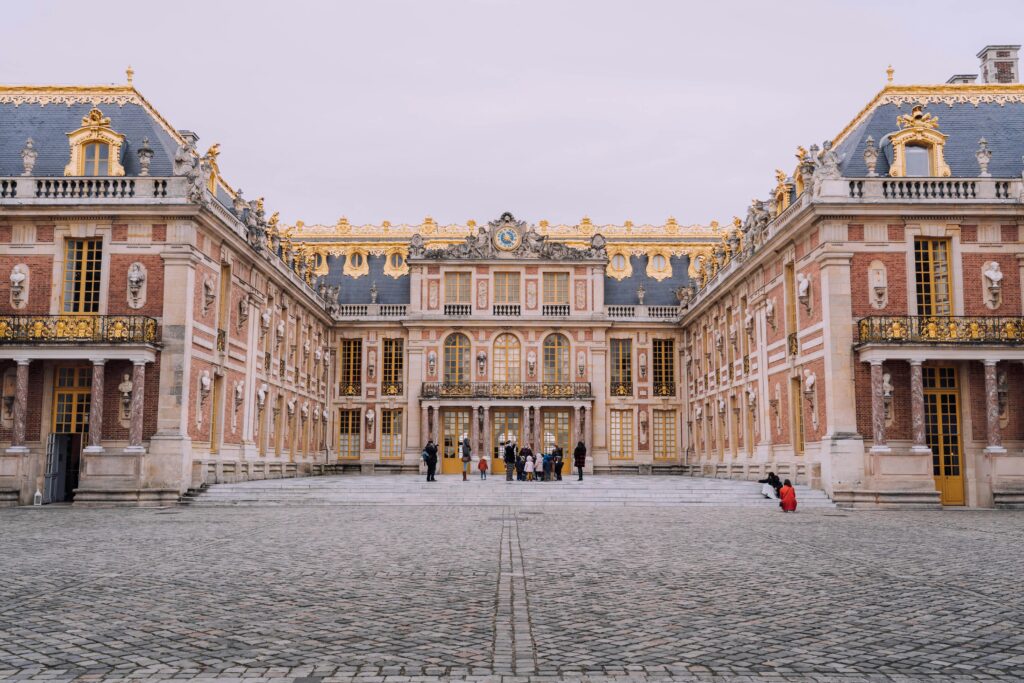 Majestic view of the Palace of Versailles courtyard showcasing its classic architecture.