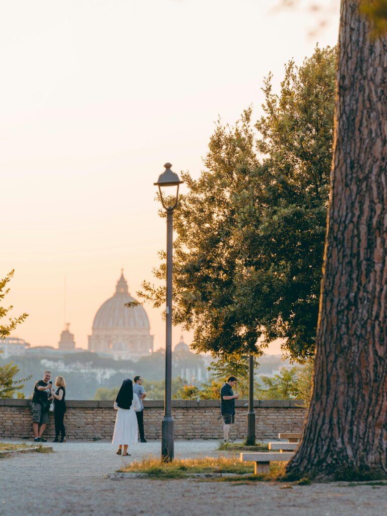 Peaceful sunset overlooking St. Peter's Basilica from a park in Rome.